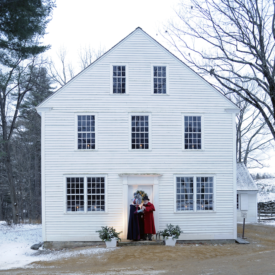 Old Sturbridge Village Christmas by Candlelight white house with couple